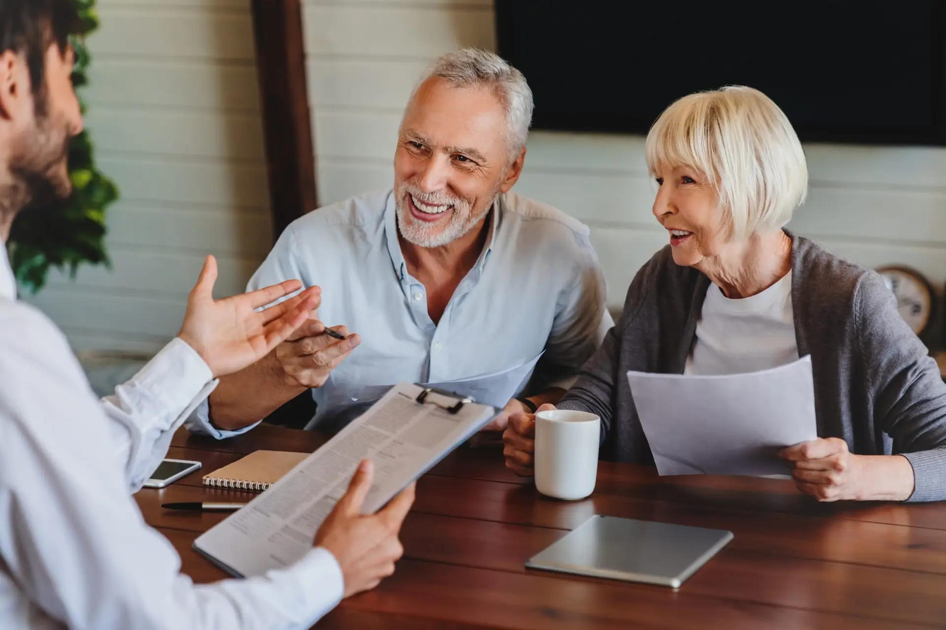 Senior expat couple consulting with insurance adviser in Spain